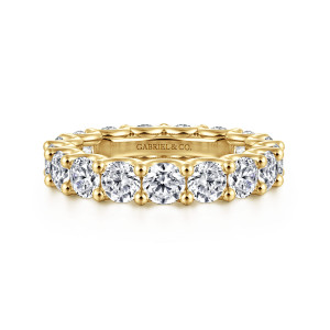 Gabriel & Co. AN17155-6Y44JJ 14 karat yellow gold Contemporary eternity band, front view of round diamonds between ball-tipped prongs, with a maker's mark on the inner wall