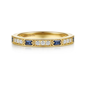 Gabriel & Co. AN17217Y44SA 14 karat yellow gold Victorian anniversary band, front view of blue baguette stones alternating with groups of round diamonds between milgrain edges