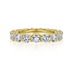 Gabriel & Co. AN4535-4Y44JJ 14 karat yellow gold Classic eternity band, front view of round diamonds with ball-tipped prongs and a maker's mark on the inner wall