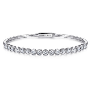 Gabriel & Co. BG3977-57W45JJ 14 karat white gold Lusso bangle, front view of the graduated diamond line above a flat clasp plate with a maker's mark