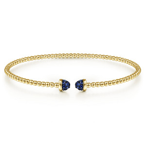 Gabriel & Co. BG4249-57Y4JSA 14 karat yellow gold Bujukan bangle, front view of a single bead strand ending in two domes covered in small blue stones