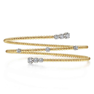 Gabriel & Co. BG4277-57M45JJ 14 karat white and yellow gold Bujukan bangle, front view of the stacked coils with graduated diamond tips at both ends