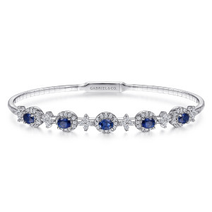 Gabriel & Co. BG4447-62W45SA 14 karat white gold Color bangle, front view of five deep blue oval stones in diamond halos with cross shaped clusters between
