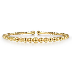 Gabriel & Co. BG4584-6Y4JJJ 14 karat yellow gold Bujukan bangle, front view of the open cuff with its largest bead at the center and a maker's mark