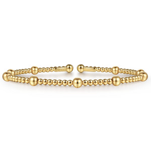 Gabriel & Co. BG4603-6Y4JJJ 14 karat yellow gold Bujukan bangle, front view of large balls among small beads and the ball tipped bar ends