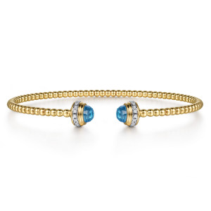 Gabriel & Co. BG4619-57Y45BT 14 karat yellow gold Bujukan bangle, front view of two blue dome caps facing each other, each with a base of small diamonds