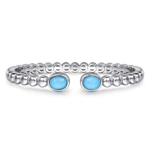 Gabriel & Co. BG4687-57SVJXT sterling silver Bujukan bangle, front view of the open cuff with a bezel-set blue oval stone at each end of the beaded band
