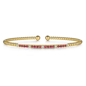 Gabriel & Co. BG4702-57Y45RA 14 karat yellow gold Bujukan bangle, front view of the prong set pinkish red row with scattered diamonds between beaded sides