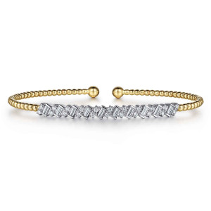Gabriel & Co. BG4705-57M44JJ 14 karat white and yellow gold Bujukan bangle, front view of the zigzag bar of baguette and round diamonds in front of the beaded gap