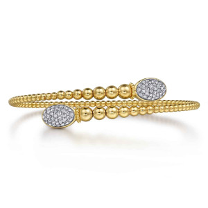 Gabriel & Co. BG4709-57Y45JJ 14 karat yellow gold Bujukan bangle, front view of the overlapping ends, each with a pave oval cap and larger beads