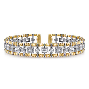 Gabriel & Co. BG4780-6M44JJ 14 karat white and yellow gold Bujukan bangle, front view of the beaded rails framing alternating baguette and round bezel stones