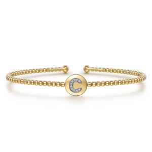 Gabriel & Co. BG4787C-57Y45JJ 14 karat yellow gold Bujukan bangle, front view of the round disc with a letter C of tiny stones between plain beads