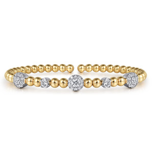 Gabriel & Co. BG4967-6M45JJ 14 karat white and yellow gold Bujukan bangle, front view showing the halo station at the middle flanked by single diamonds and round clusters