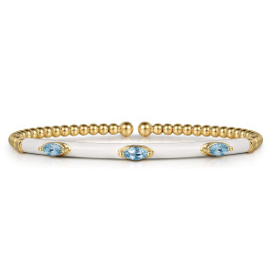 Gabriel & Co. BG4968E9Y4JBT 14 karat yellow gold Bujukan bangle, front view of the white enamel bar with blue marquise stones and the beaded ends