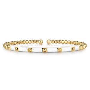 Gabriel & Co. BG4969E9Y4JJJ 14 karat yellow gold Bujukan bangle, front view of the beaded cuff with its pale enamel bar and row of metal pyramids