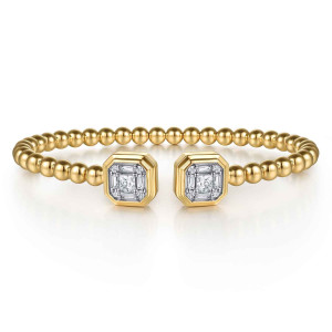 Gabriel & Co. BG5074-57Y44JJ 14 karat yellow gold Bujukan bangle, front view of two clipped-corner square caps, each with a square stone ringed by baguettes