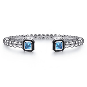 Gabriel & Co. BG5095E8SVJBT sterling silver Bujukan bangle, front view of the two square caps facing each other, light blue stones in black enamel