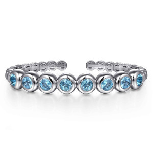Gabriel & Co. BG5109-57SVJBT sterling silver Bujukan bangle, front view of a row of round blue stones in smooth puffed bezels across the cuff
