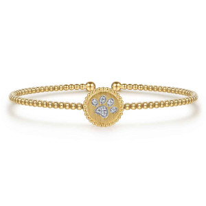 Gabriel & Co. BG5140-57Y45JJ 14 karat yellow gold Bujukan bangle, front view of the round medallion, its beaded rim and the diamond paw print