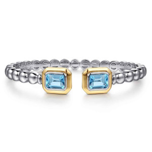 Gabriel & Co. BG5148-57MZJBT sterling silver and 14 karat yellow gold Bujukan bangle, front view of an open beaded cuff with a framed light blue stone at each end