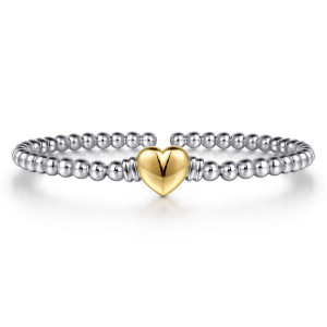Gabriel & Co. BG5212-57MZJJJ sterling silver and 14 karat yellow gold Bujukan bangle, front view of the single puffed heart framed by ribbed collars on the bead strand