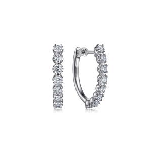 Gabriel & Co. EG14766W45JJ 14 karat white gold Lusso earrings, front view of the pair, one huggie face on and one edge on, with prongs holding each stone
