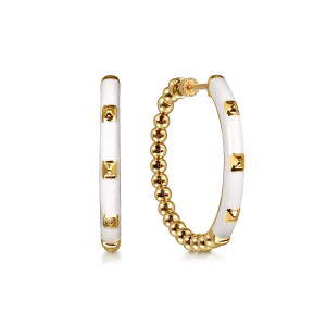 Gabriel & Co. EG15177E9Y4JJJ 14 karat yellow gold Bujukan earrings, front view of two hoops with pale milky enamel faces and a row of raised pyramid studs