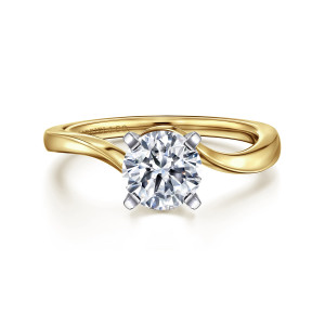 Gabriel & Co. ER11588R4M4JJJ 14 karat white and yellow gold Contemporary engagement ring, front view of a round center in four flat sided prongs beside the sweeping band