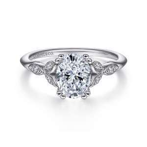 Gabriel & Co. ER11721O4PT4JJ platinum Victorian engagement ring, front view of an oval center flanked by leaf shaped motifs with small diamonds