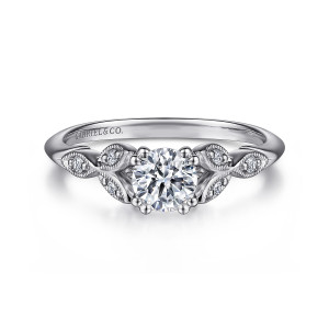 Gabriel & Co. ER11721R2W44JJ 14 karat white gold Victorian engagement ring, front view of a round center with beaded paired prongs between leaf motifs holding tiny diamonds