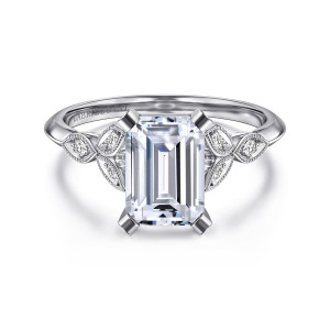 Gabriel & Co. ER11747E8W44JJ 14 karat white gold Victorian engagement ring, front view of an emerald cut center in flat topped corner claws between leaf frames