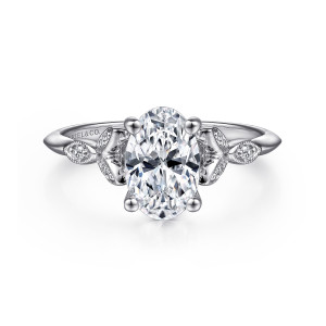 Gabriel & Co. ER11747O6W44JJ 14 karat white gold Victorian engagement ring, front view of an oval center with ball tipped prongs and leaf frames tapering into a slender band