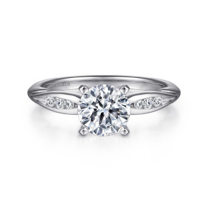 Gabriel & Co. ER11749R4W44JJ 14 karat white gold Contemporary engagement ring, front view of a round center in four prongs between two leaf shaped shoulder panels