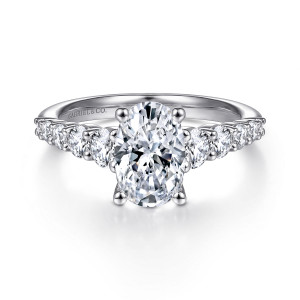 Gabriel & Co. ER11757O6W44JJ 14 karat white gold Classic engagement ring, front view of an oval center flanked by rows of round diamonds in shared prongs along the shoulders