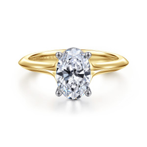 Gabriel & Co. ER11832O6M4JJJ 14 karat white and yellow gold Classic engagement ring, front view of an oval center in prongs with rounded tips and a ridged edge on each shoulder