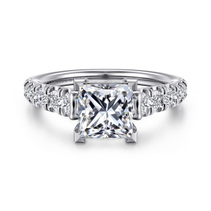 Gabriel & Co. ER12299S6W44JJ 14 karat white gold Classic engagement ring, front view of a princess cut center in V shaped corner prongs with round diamonds beside the head