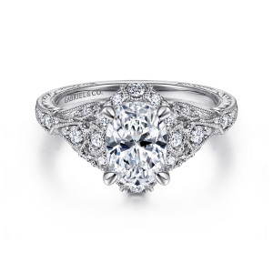 Gabriel & Co. ER12579O4W44JJ 14 karat white gold Victorian engagement ring, front view of an oval center inside a small diamond halo with beaded leaf settings beside it
