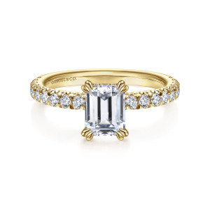 Gabriel & Co. ER13904E4Y44JJ 14 karat yellow gold Classic engagement ring, front view of an emerald cut center held by paired claws at each corner over a diamond band