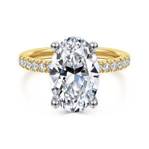 Gabriel & Co. ER13904O16M44JJ 14 karat white and yellow gold Classic engagement ring, front view of an oval center on ball tipped prongs with round diamonds along both shoulders