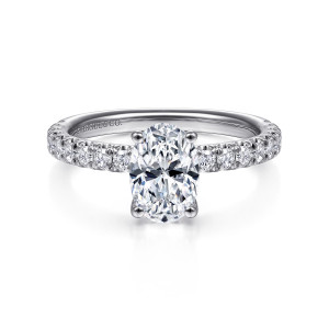 Gabriel & Co. ER13904O4W44JJ 14 karat white gold Classic engagement ring, front view of an oval center on four claws with round diamonds crowding both shoulders