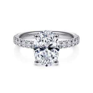 Gabriel & Co. ER13904O8W44JJ 14 karat white gold Classic engagement ring, front view of an oval center on four rounded prongs between diamond lined shoulders