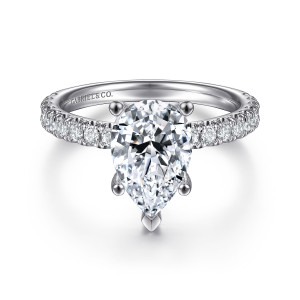 Gabriel & Co. ER13904P8W44JJ 14 karat white gold Classic engagement ring, front view of a pear shaped center with a V tip claw above round diamonds on the shoulders