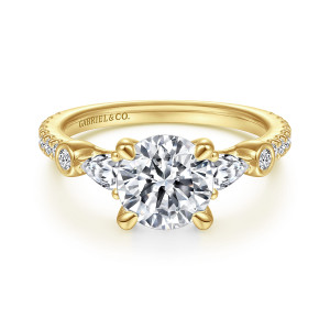Gabriel & Co. ER14516R6Y44JJ 14 karat yellow gold Classic engagement ring, front view of a round center with pear shaped stones pointing outward and bezel stones beyond