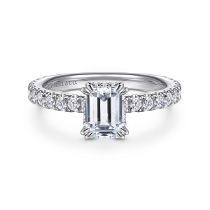 Gabriel & Co. ER14649E4W44JJ 14 karat white gold Classic engagement ring, front view of paired claw prongs holding an emerald cut center, with a maker's mark inside the band