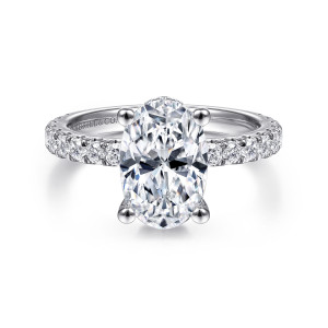 Gabriel & Co. ER14649O8W44JJ 14 karat white gold Classic engagement ring, front view of the oval center in four claw prongs on a band of round diamonds