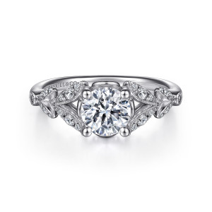 Gabriel & Co. ER14662R4W44JJ 14 karat white gold Victorian engagement ring, front view of the round center flanked by branching milgrain leaf panels on both shoulders