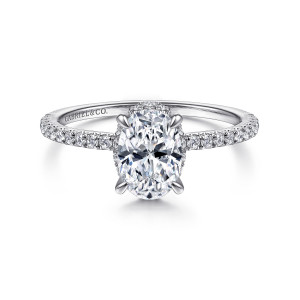 Gabriel & Co. ER14719O4W44JJ 14 karat white gold Classic engagement ring, front view of an oval center on slim claw prongs with halo stones glinting at its edges