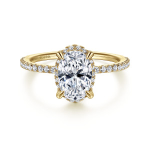 Gabriel & Co. ER14719O6Y44JJ 14 karat yellow gold Classic engagement ring, front view of an oval center on tapered prongs with small diamonds peeking out below its edge