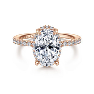 Gabriel & Co. ER14719O8K44JJ 14 karat rose gold Classic engagement ring, front view of an oval center in tapered prongs with small diamonds peeking out around its edge