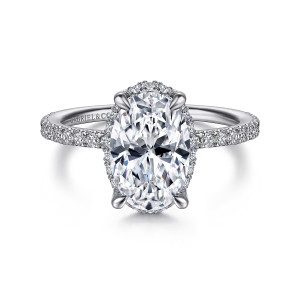 Gabriel & Co. ER14719O8W44JJ 14 karat white gold Classic engagement ring, front view of an oval center on four leaf tipped prongs with halo stones peeking around its edge